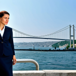 Professional Businesswoman**

"A professional businesswoman in a modest business suit, standing in front of the Bosphorus Bridge in Istanbul, fully clothed, appropriate attire, safe for work, perfect anatomy, natural proportions, professional photography, high quality."

**